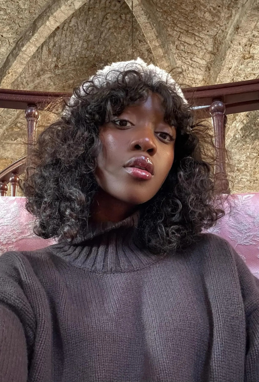 @emmanuellek_ shows torn bangs on curly hair