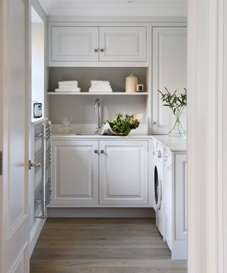 small utility room with white cupboards