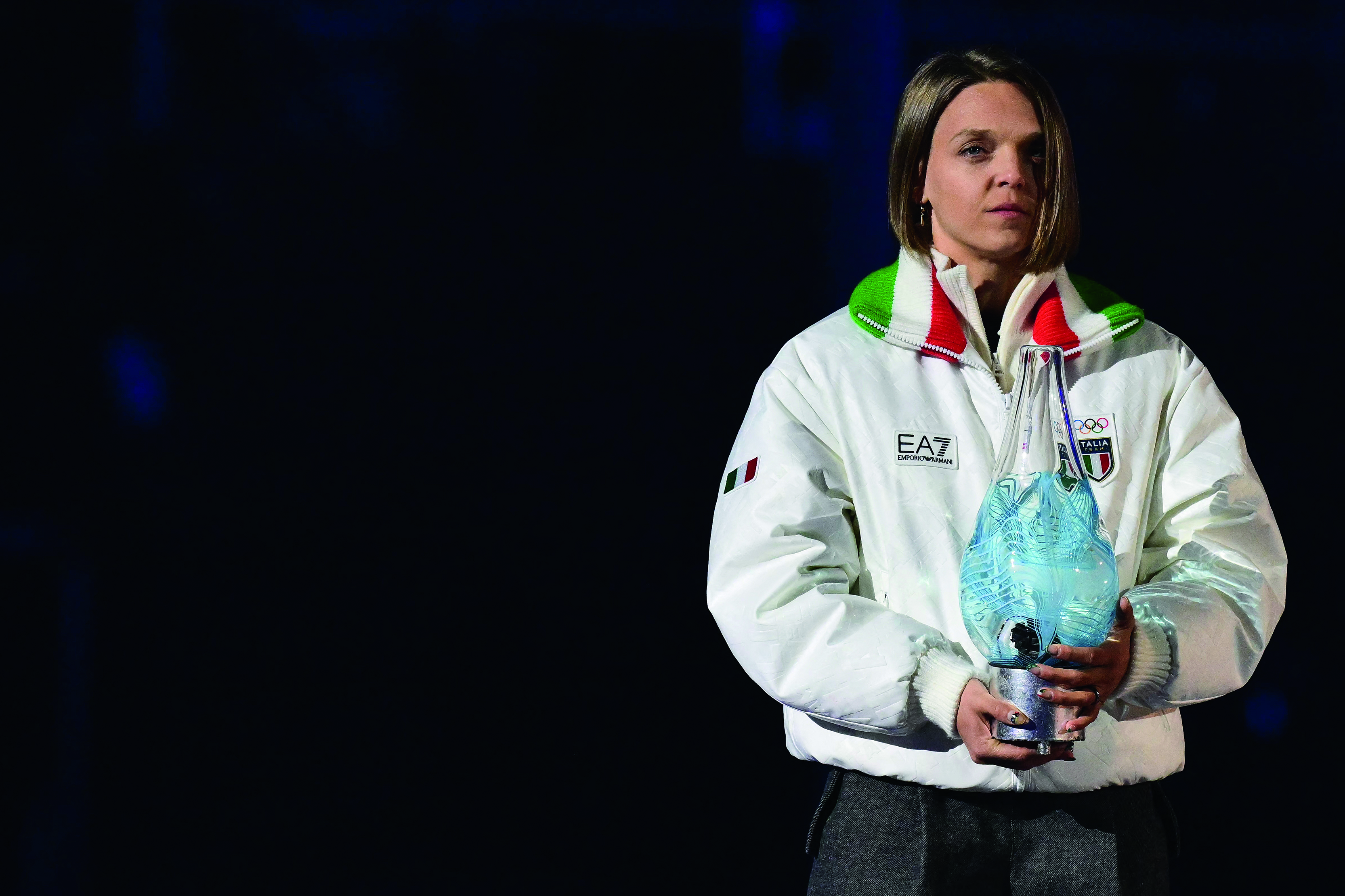 Italy's speed skater Arianna Fontana carries the Murano glass lamp after the Olympic flame was extinguished during the closing ceremony of the Milano Cortina 2026 Winter Olympic Games at the Verona Arena in Verona, northern Italy, on February 22, 2026.