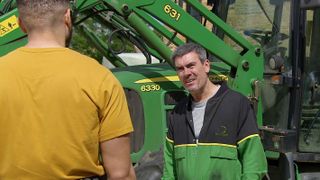 Cain Dingle confronts Nate Robinson with a green machine in the background.