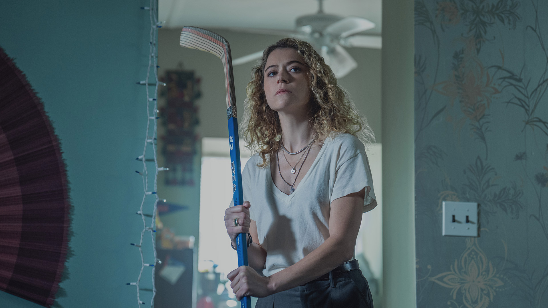 Tatiana Maslany holds a hockey stick in Apple TV's Maximum Pleasure Guaranteed