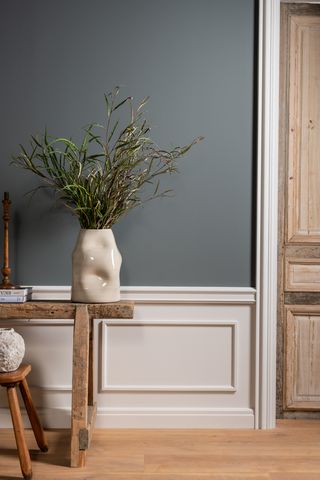 A hallway with low wood panelled walls