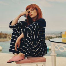 Natasha Lyonne wearing la ligne travel pajamas while sitting by a pool