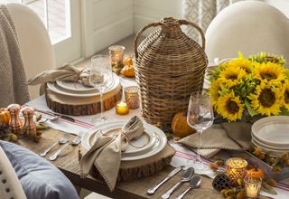 fall decor table setting with wood, linen, sunflowers