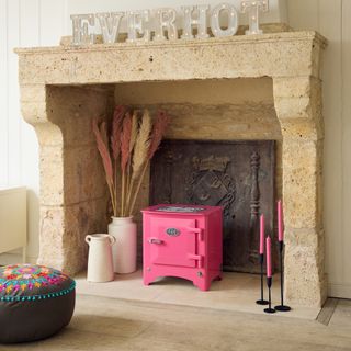 stone fireplace with pink electric stove
