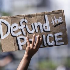 manhattan, ny june 19 a protester holds up a homemade sign that says, "defund the police" with the manhattan bridge behind them as they perform a peaceful protest walk across the brooklyn bridge this was part of the unite ny 2020, bringing all of new york together rally and march for black lives matter as protests that happened around the country to celebrate juneteenth day which marks the end of slavery in the united states protesters continue taking to the streets across america and around the world after the killing of george floyd at the hands of a white police officer derek chauvin that was kneeling on his neck during for eight minutes, was caught on video and went viral during his arrest as floyd pleaded, "i can't breathe" the protest are attempting to give a voice to the need for human rights for african american's and to stop police brutality against people of color they are also protesting deep seated racism in america many people were wearing masks and observing social distancing due to the coronavirus pandemic photographed in the manhattan borough of new york on june 19, 2020, usa photo by ira l blackcorbis via getty images