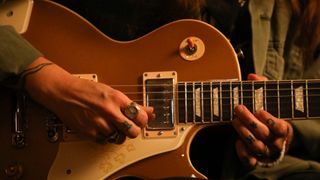 A close-up photo of Emily Wolfe playing the Gibson Mary Ford Les Paul Standard