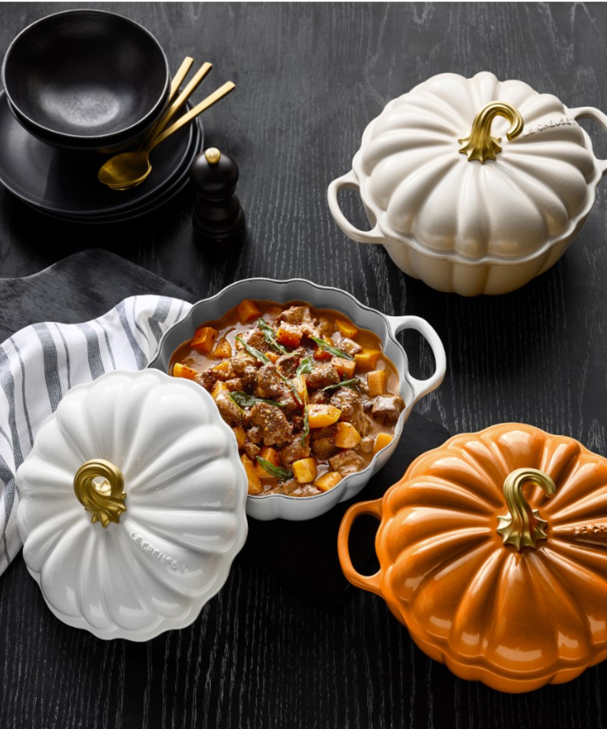 Le Creuset white and orange pumpkin shaped cocottes with a seasonal casserole