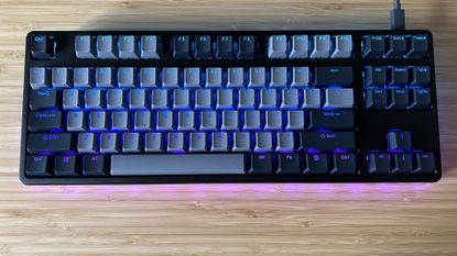 Drop CTRL V2 keyboard on a wooden desk