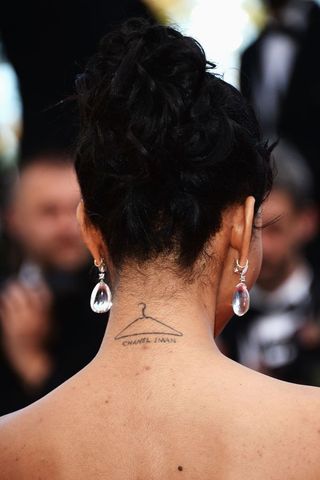 Chanel Iman with hanger tattoo on back on neck