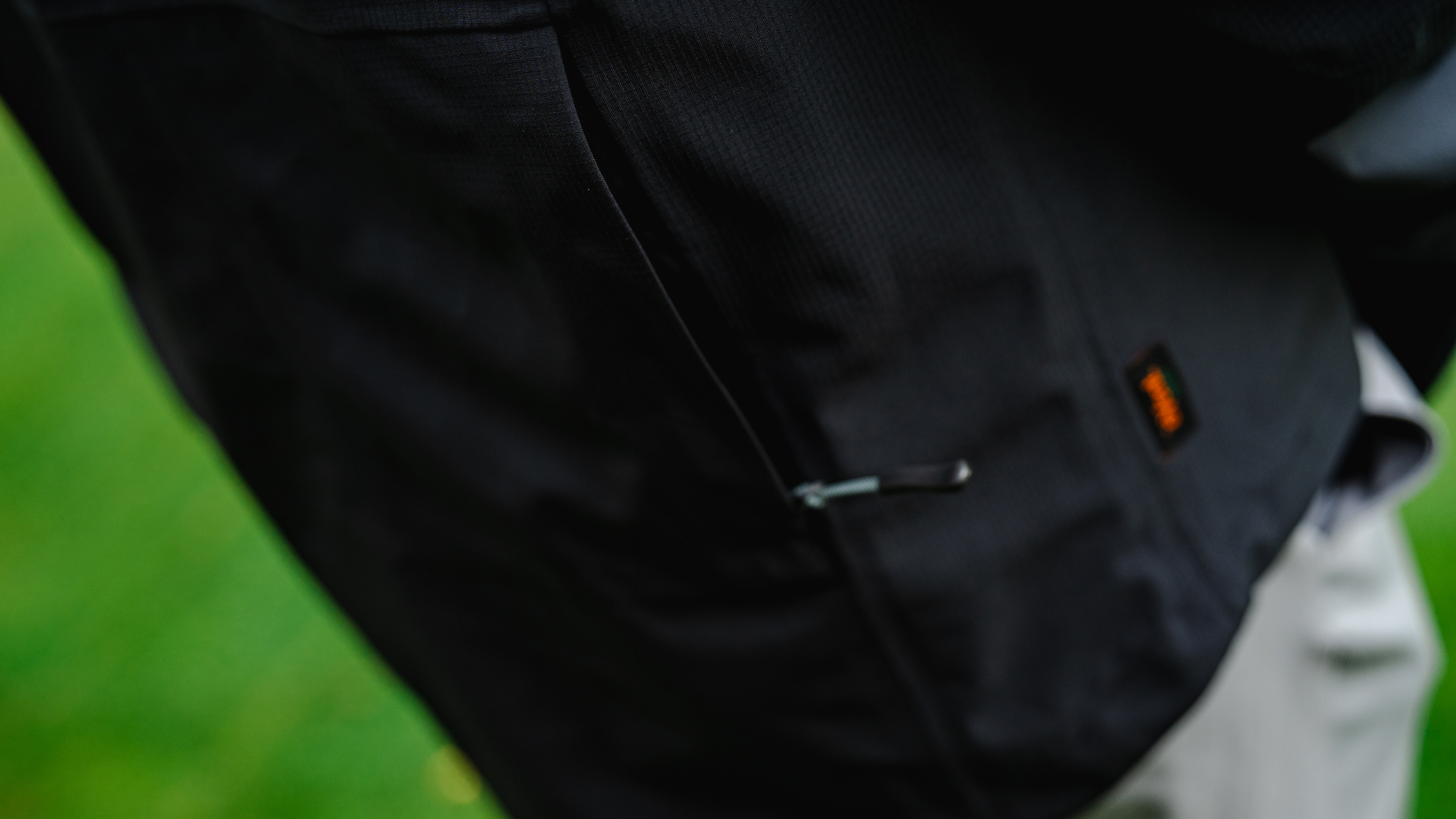 A close-up of the back pocket on a HLINC Full Zip Waterproof Golf Links Jacket