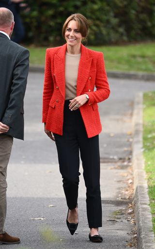 Kate Middleton in a red zara blazer and black trousers walking in Kent