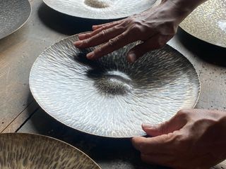 Adaesi Ukairo touches metal plate