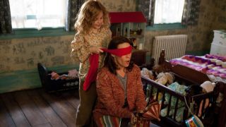 Kyla Deaver's character blindfolds Lili Taylor's character in The Conjuring.