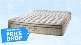 A Saatva Classic mattress on a pale blue background with a deals tag in the foreground.