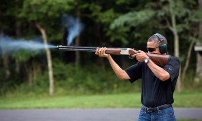 President Obama shoots clay targets with a shotgun on the range on August 4, 2012 at Camp David, Maryland.