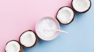 bowl of coconut oil on pink and blue background