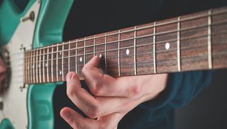 A guitarist tears up the fretboard