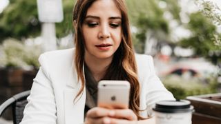 woman using her iphone for work