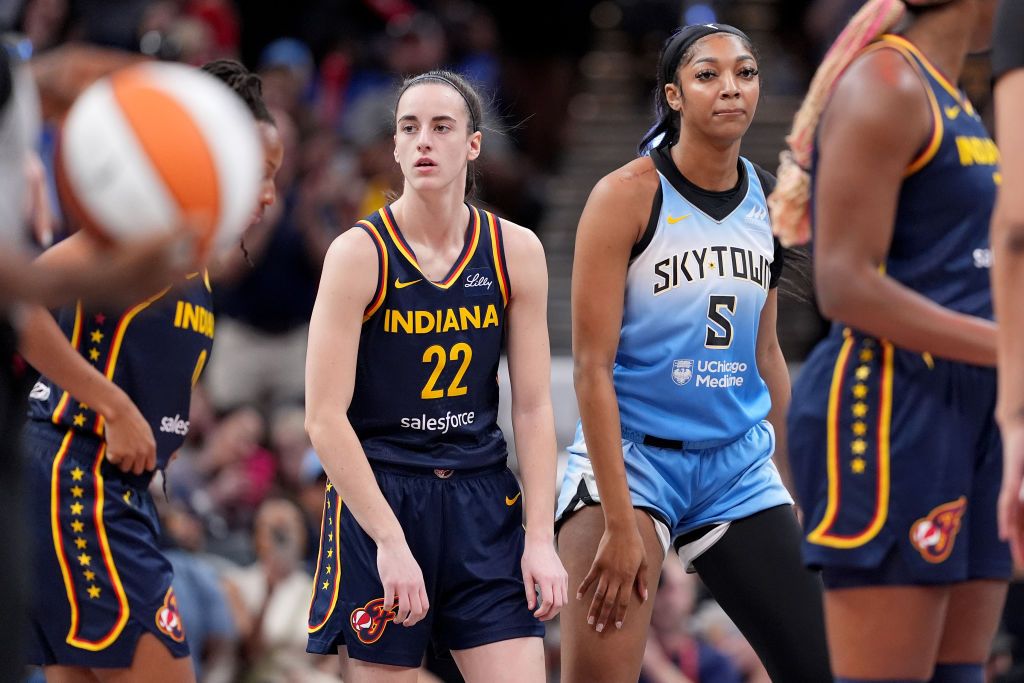 Caitlin Clark #22 of the Indiana Fever and Angel Reese #5 of the Chicago Sky look on during a game at Gainbridge Fieldhouse on June 16, 2024