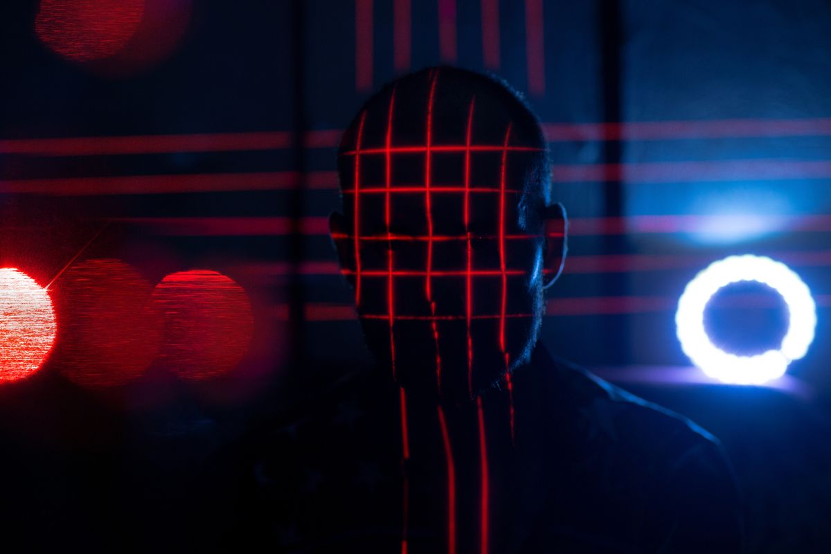 The outline of a mysterious figure surrounded by red and blue lights