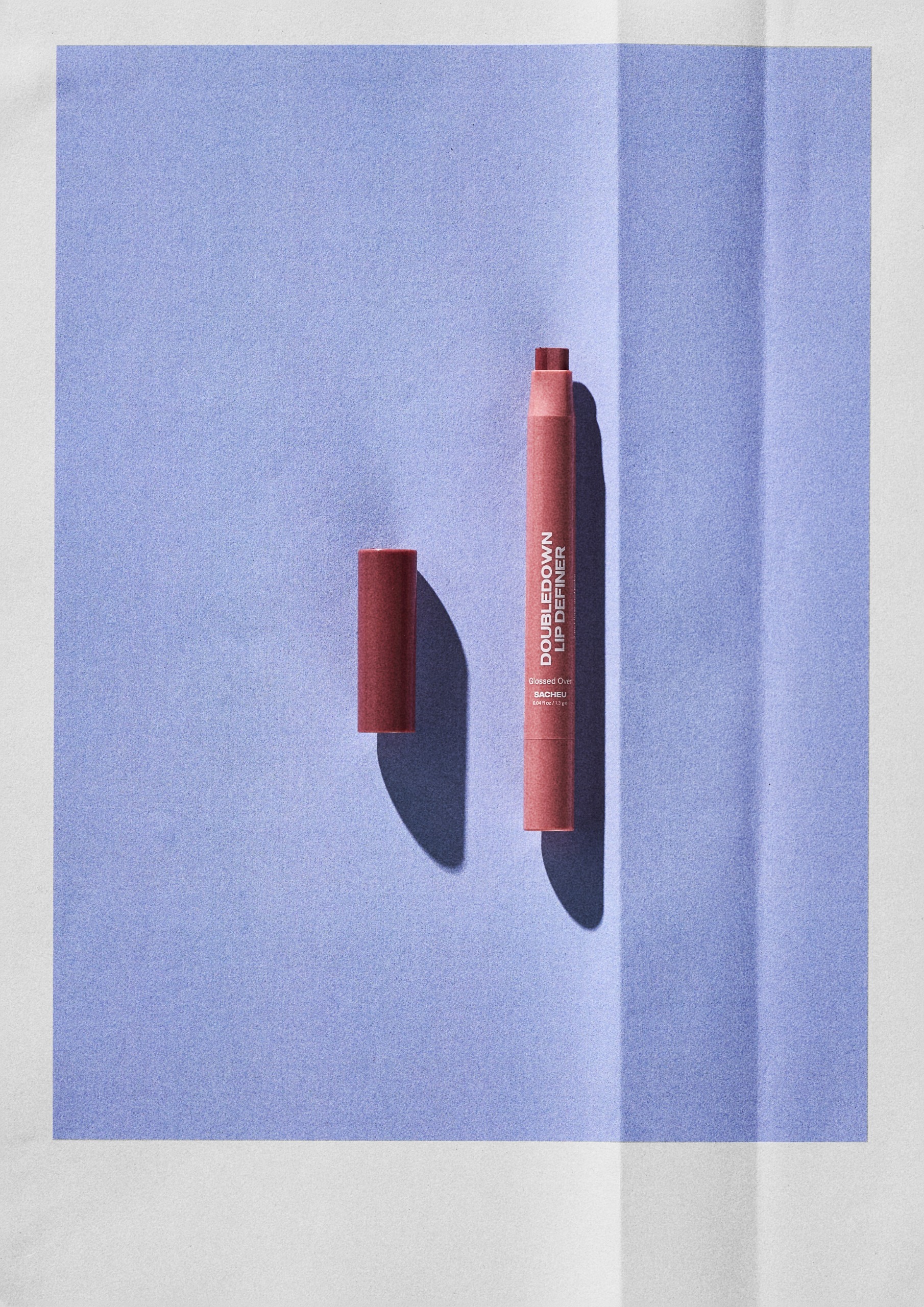Sacheu DoubleDown Lip Definer on a blue background