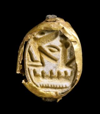 A gold scarab seal found in the Israeli grave.
