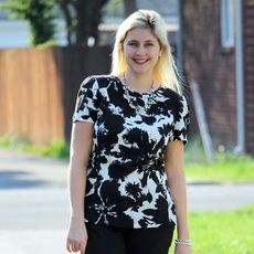 catherine hageman black pants black floral top red sandals