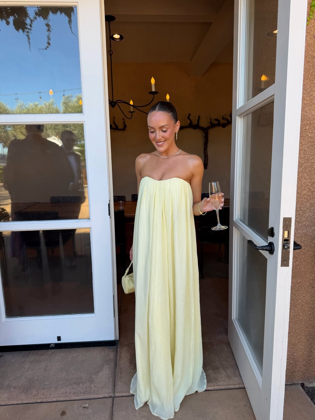 NYC woman wears a butter yellow gown as a wedding guest.