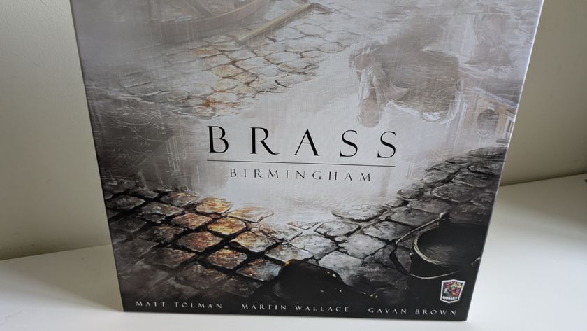 Brass: Birmingham box showing a puddle in a cobbled street, against a plain white wall