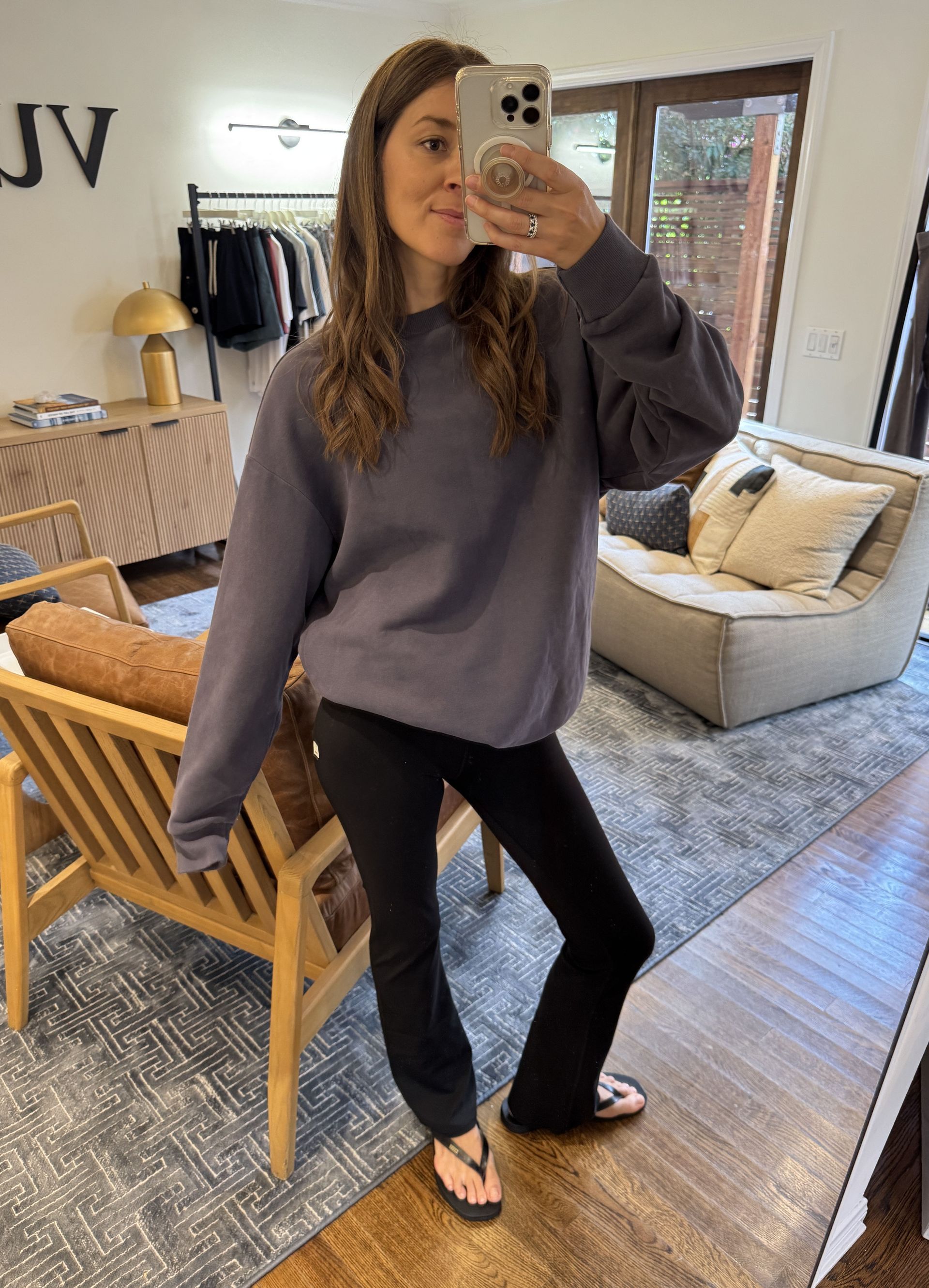 Woman in gray sweatshirt and black pants.