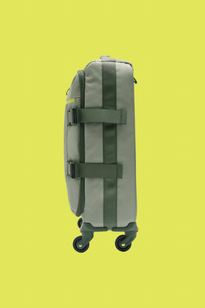 Rotating gif of Parfois Nylon Travel Suitcase against bright yellow background.