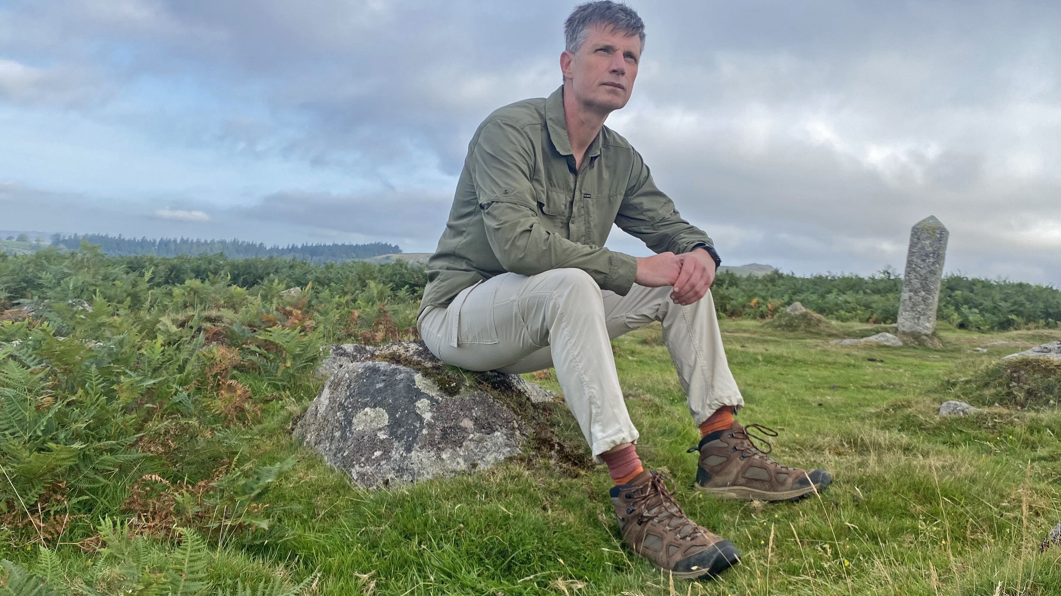 Walker wearing the Buff LW merino hiking Socks, sat on a rock on Dartmoor