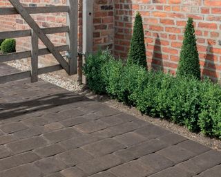 cobble design block paving with topiary and wooden 5-bar gate