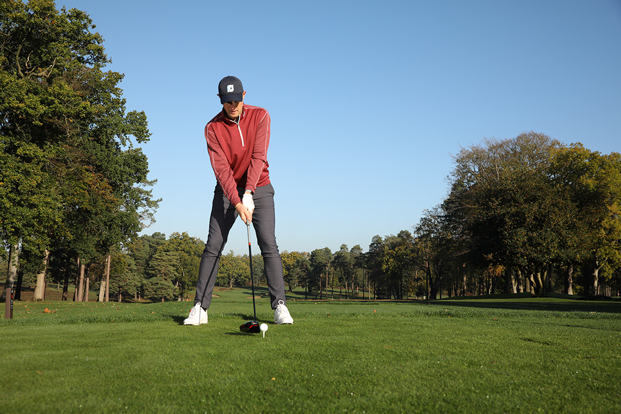 Neil Tappin setting up to hit a driver with the ball teed up slightly higher, his stance slightly wider and a shoulder tilt to promote more distance off the tee