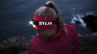 Woman wearing Silva Trail Runner Free headlamp