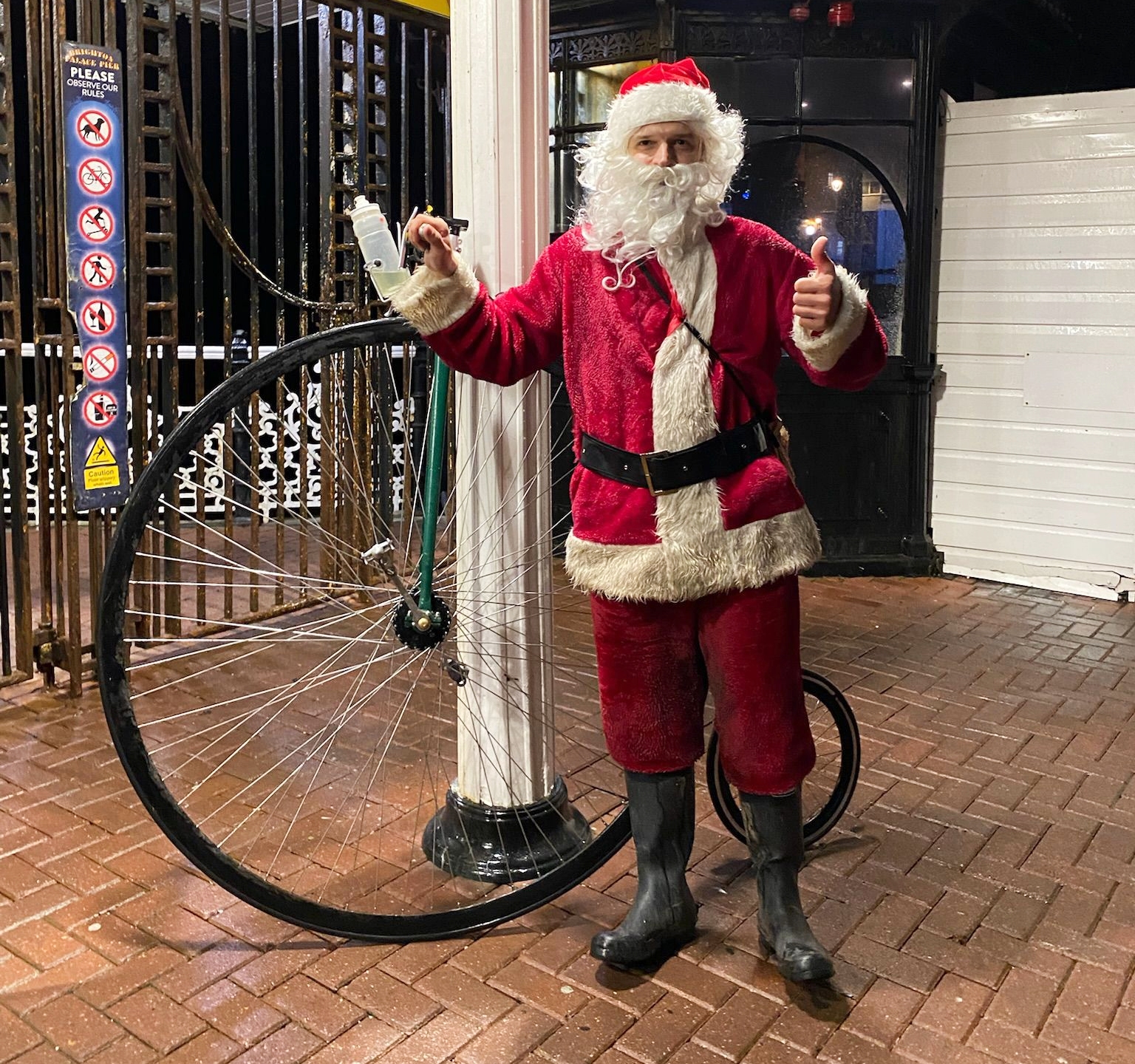 Charlie Burrell with a penny-farthing in a Santa costume