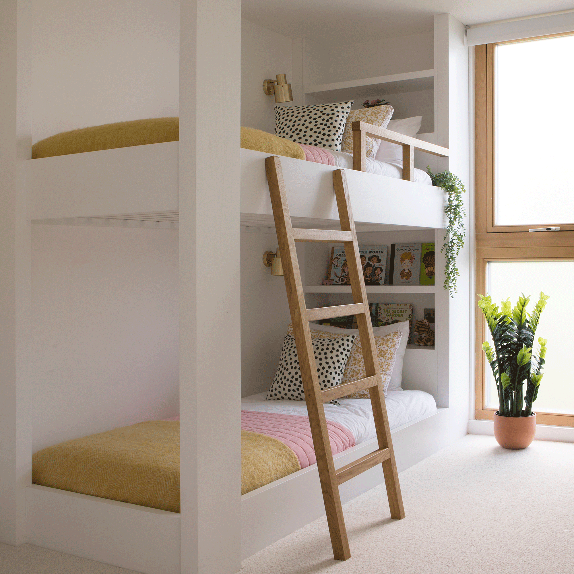 Bunk bed in white room with built in step ladder