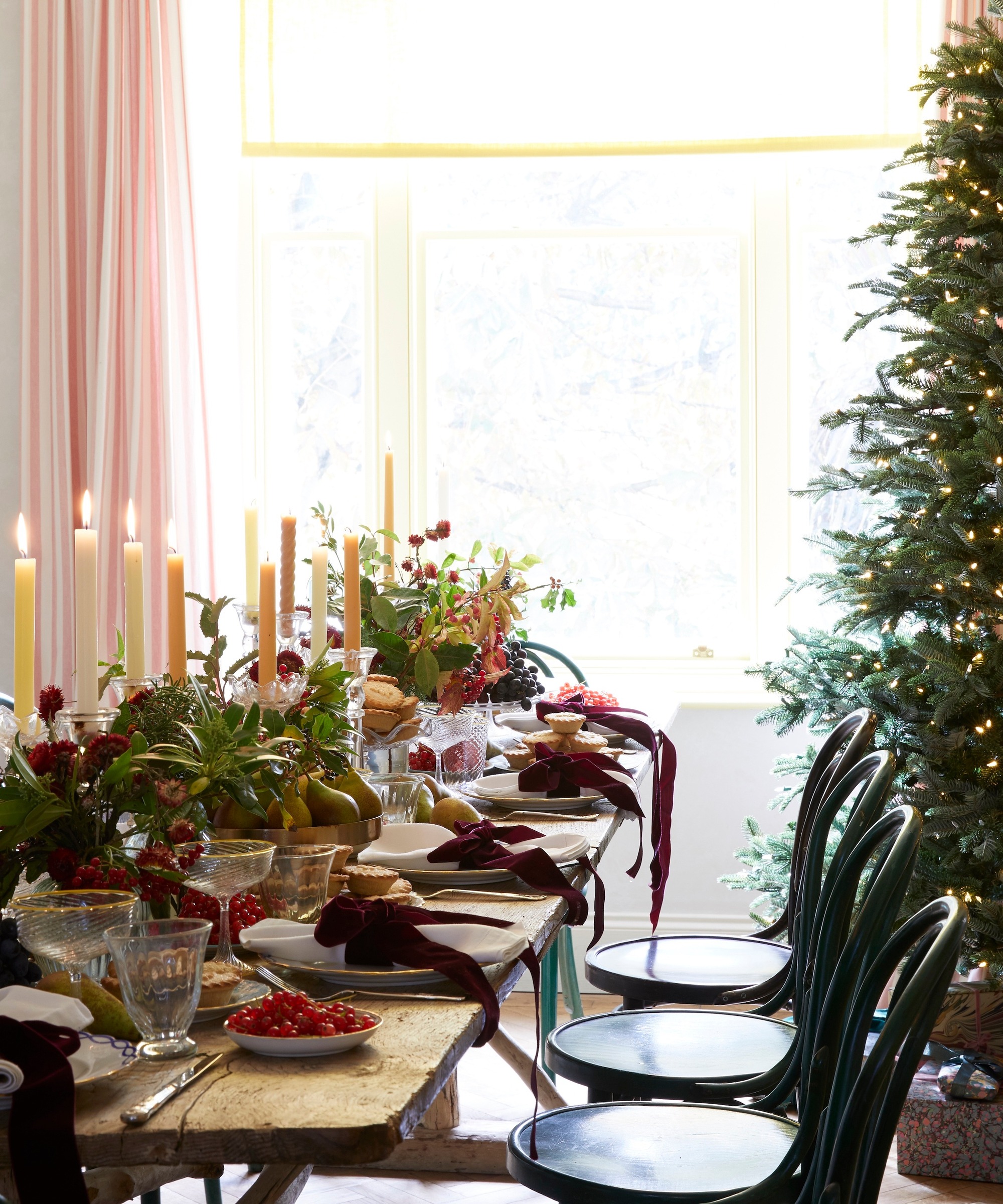 A Christmas table set with flowers and candles