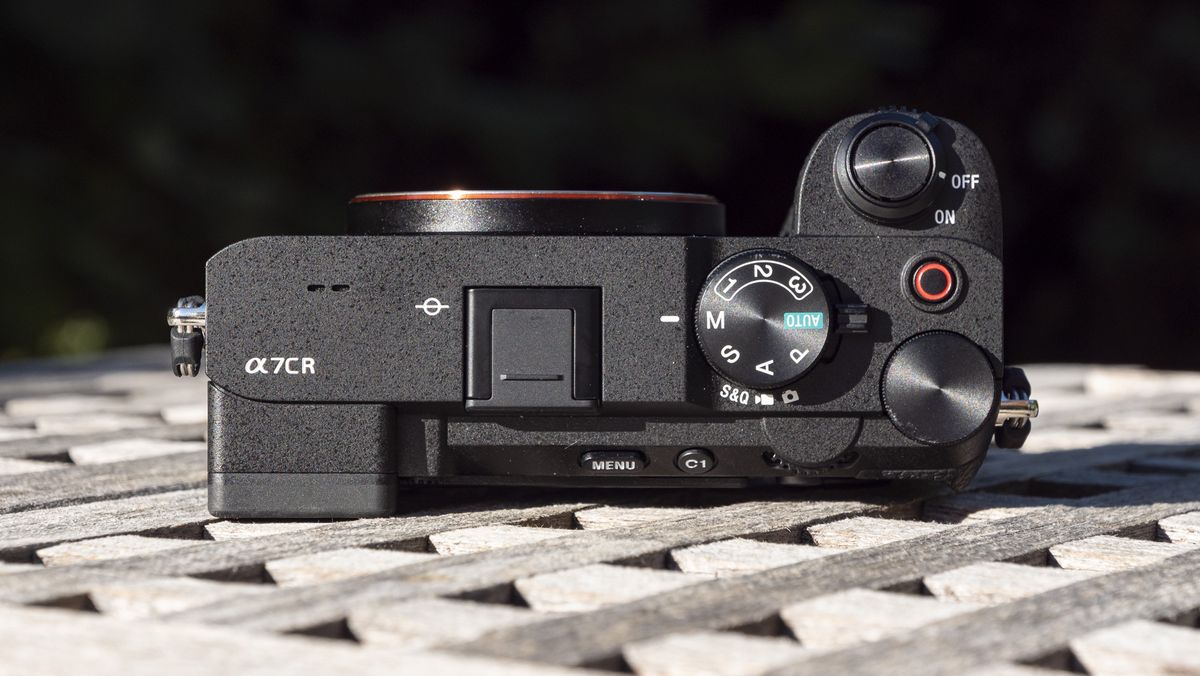 Top plate of the Sony A7C R mirrorless camera outside on a wooden table