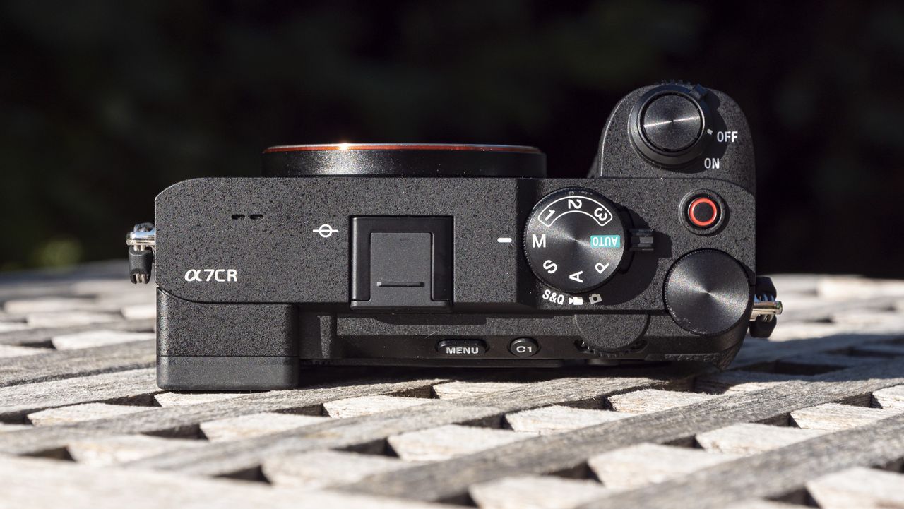 Top plate of the Sony A7C R mirrorless camera outside on a wooden table