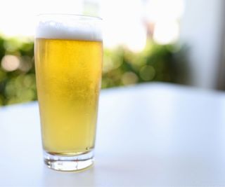 Beer glass on a white surface outside