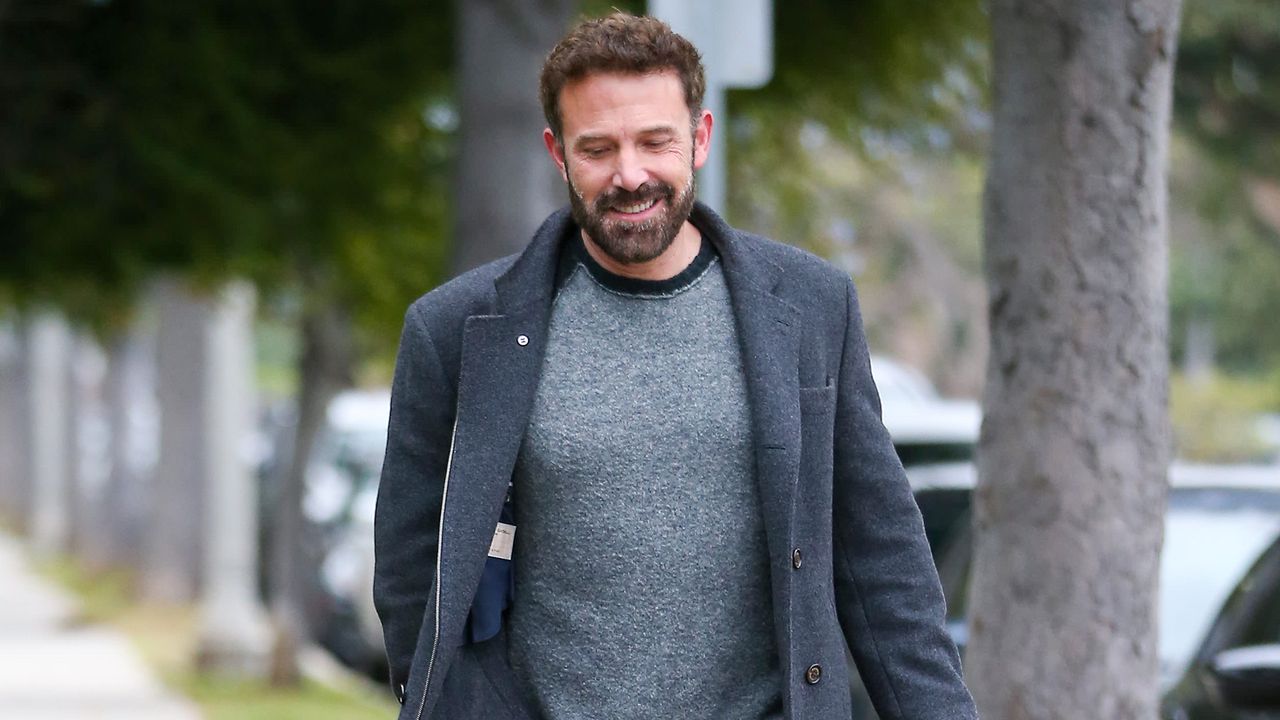 Ben Affleck wearing a gray shirt and gray coat while walking in Los Angeles.