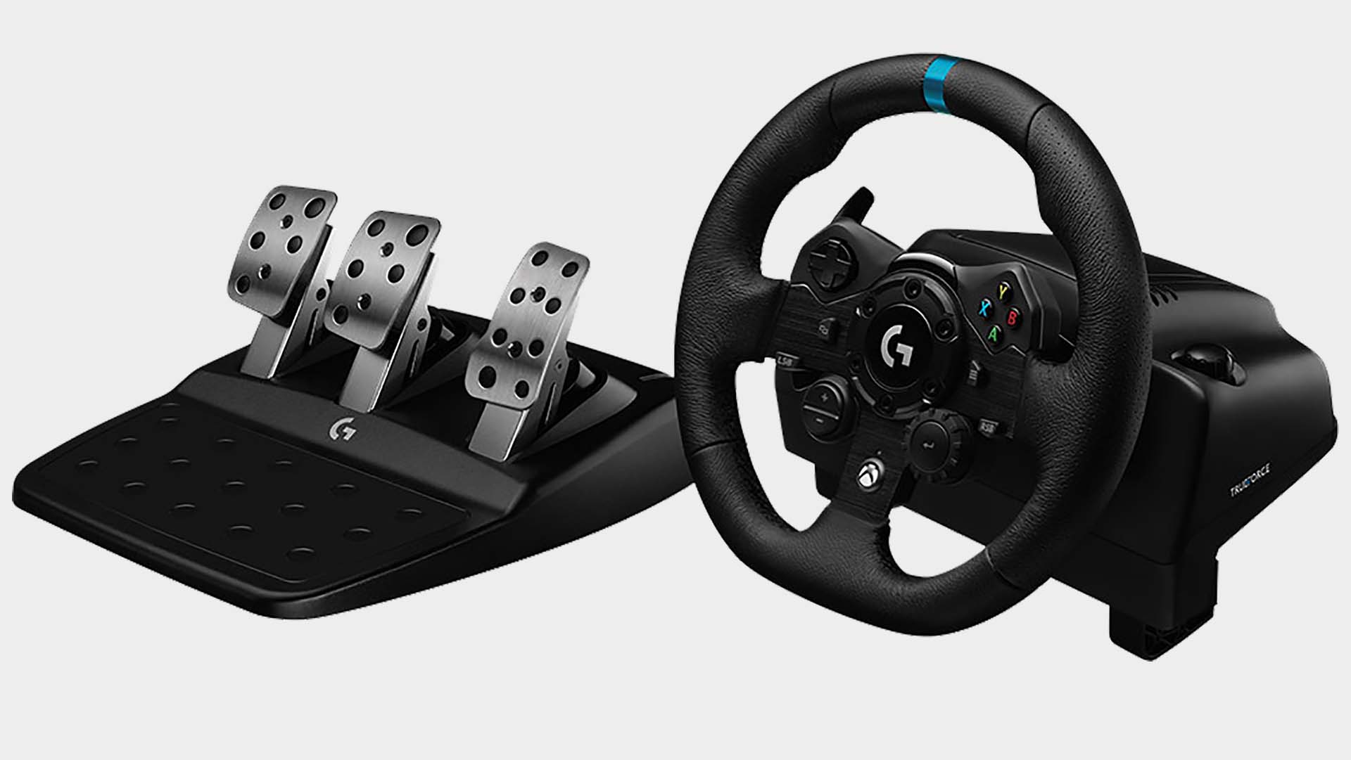 The Logitech G923 racing wheel with pedals on a grey background