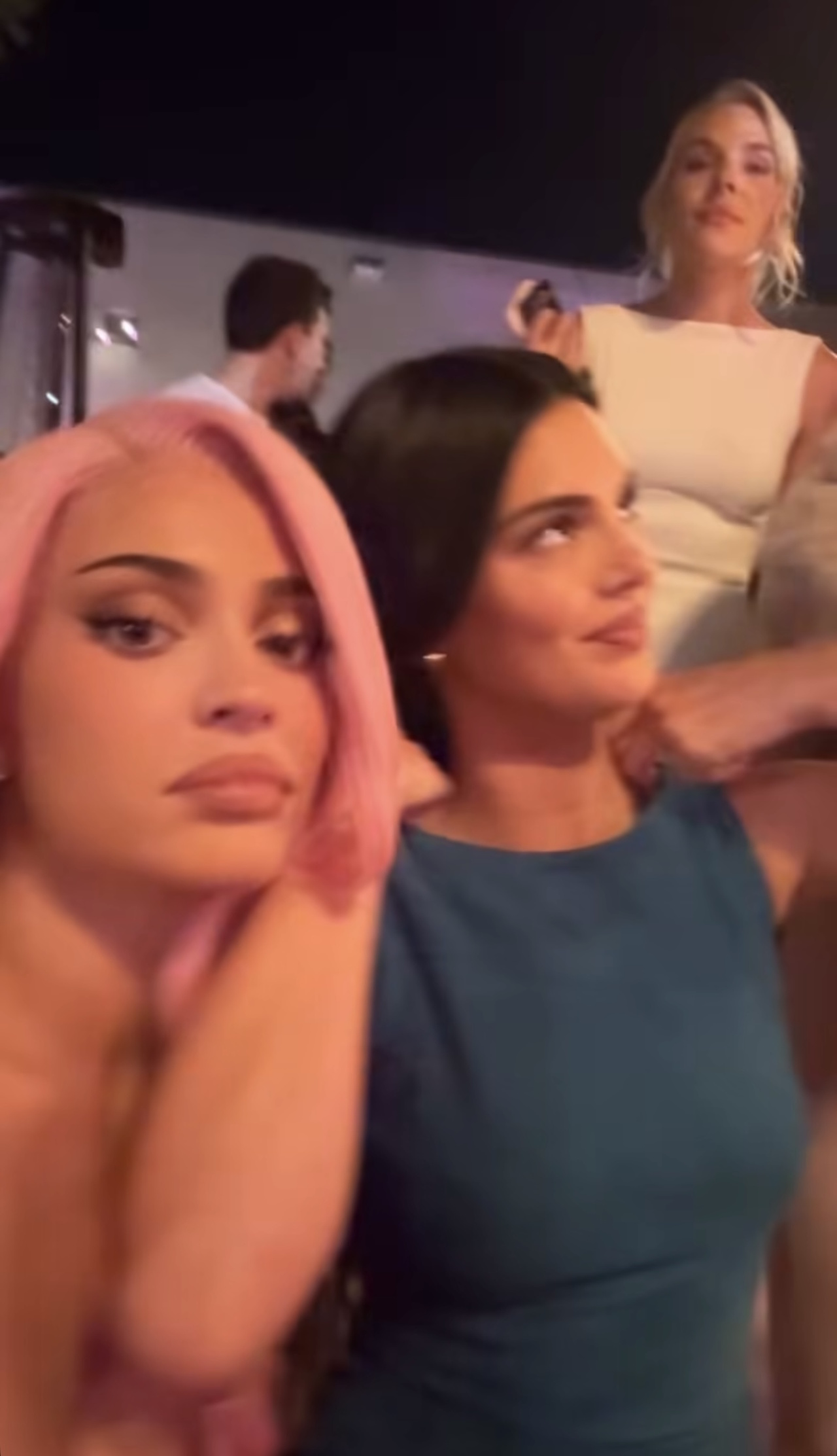 Kylie Jenner and Kendall Jenner take selfies at a Kylie Cosmetics anniversary party.