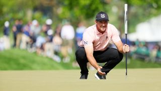 Bryson DeChambeau of the United States reacts as he lines up a putt on the ninth green during the first round of the 2023 PGA Championship at Oak Hill Country Club on May 18, 2023 in Rochester, New York.