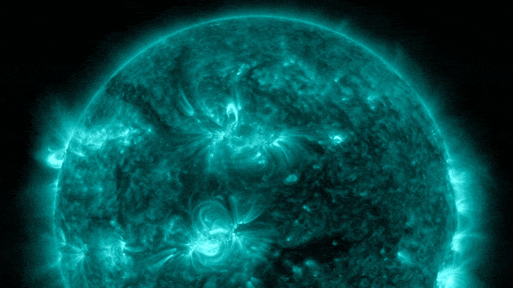 Looped video footage of two solar flares simultaneously exploding on the sun