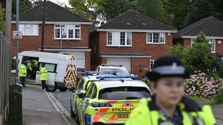 A police officer at the scene in Bushey, England, after the attack by Kyle Clifford