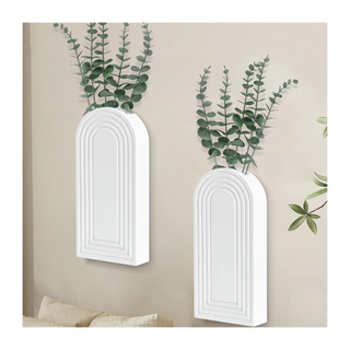 A pair of white wall planters