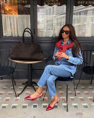 @symphonyofsilk wearing double denim, red jumper and red heels